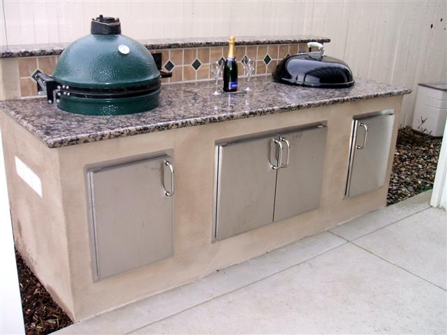 Big Green Egg and Weber Kettle in custom BBQ island with granite counter top
